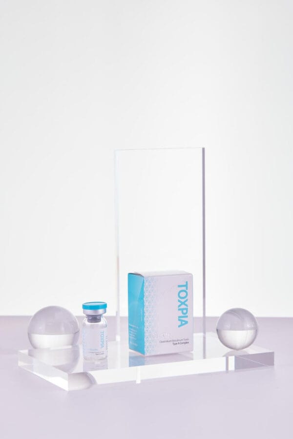 a glass and plastic objects on a table